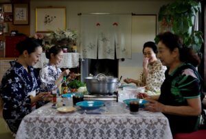 Japanese women sit around a dinner table