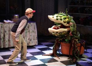 Seymour and Audrey II face off in the Lyric Stage Company of Boston's production of "Little Shop of Horrors"