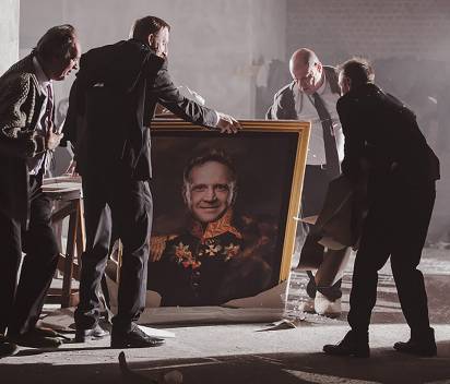 photo of several actors surrounding a painted portrait of a lead character in Boris directed by Dmitry Krymov